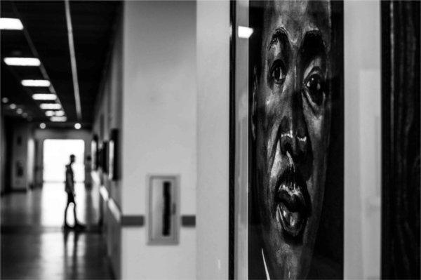  The silhouette of a student walks near a painting of Dr. Martin Luther King, Jr. 